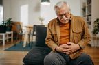 man with colon cancer experiencing stomach pain 