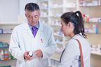 pharmacist giving medication to woman 