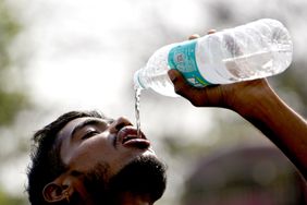 A boy sips water from a bottle during heatwave in Kolkata, India, 29 March, 2022. The temperature in the afternoon touches 42 degree according to an Indian Meteorological Department of Kolkata