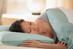 Woman lying in bed can't sleep