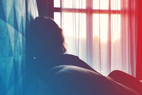 Rear View Of Woman Relaxing On Bed At Home , mental-health-pandemic , pandemic , covid-19 , coronavirus , lockdown , quarantine