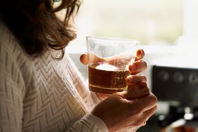 Woman drinking whiskey alone