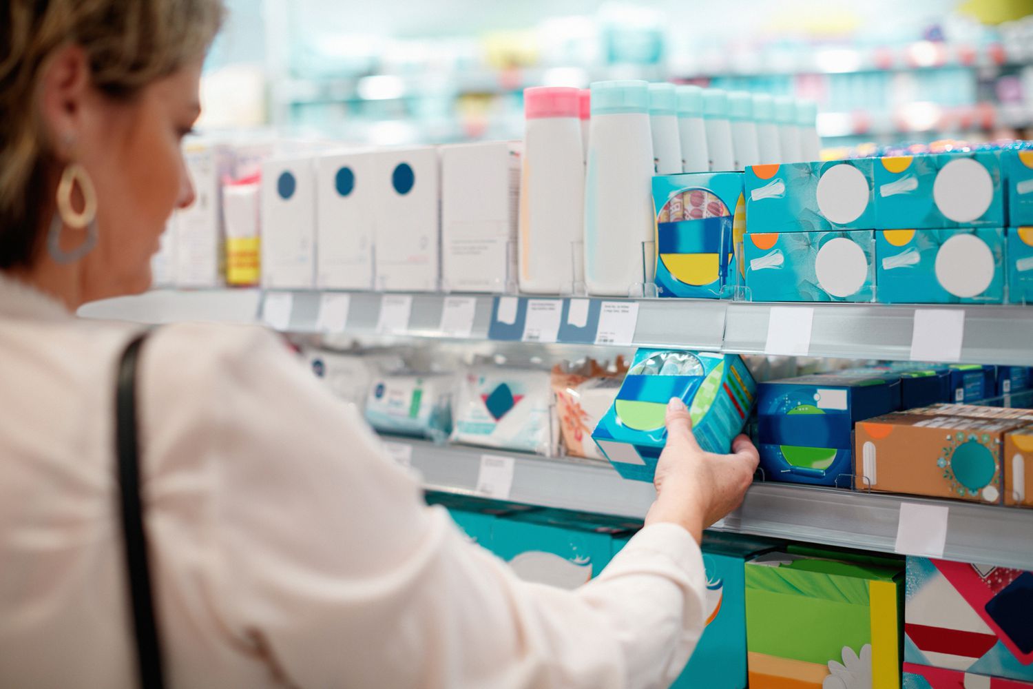 Woman buying sanitary pads at store