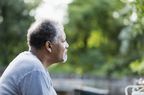 Senior African-American man outdoors, thinking