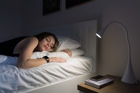 young woman sleeping with sleep tracker