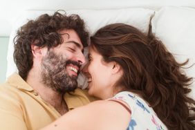 Couple laughing in bed