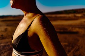 Heat Exhaustion Symptoms - Midsection Of Woman Sweating At Land During Sunny Day