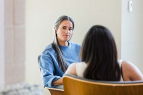 patient listens with displeased look on her face to her therapist