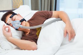 person with sleep apnea using cpap machine device