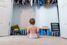 Boy toddler trying to choose a toy to play with